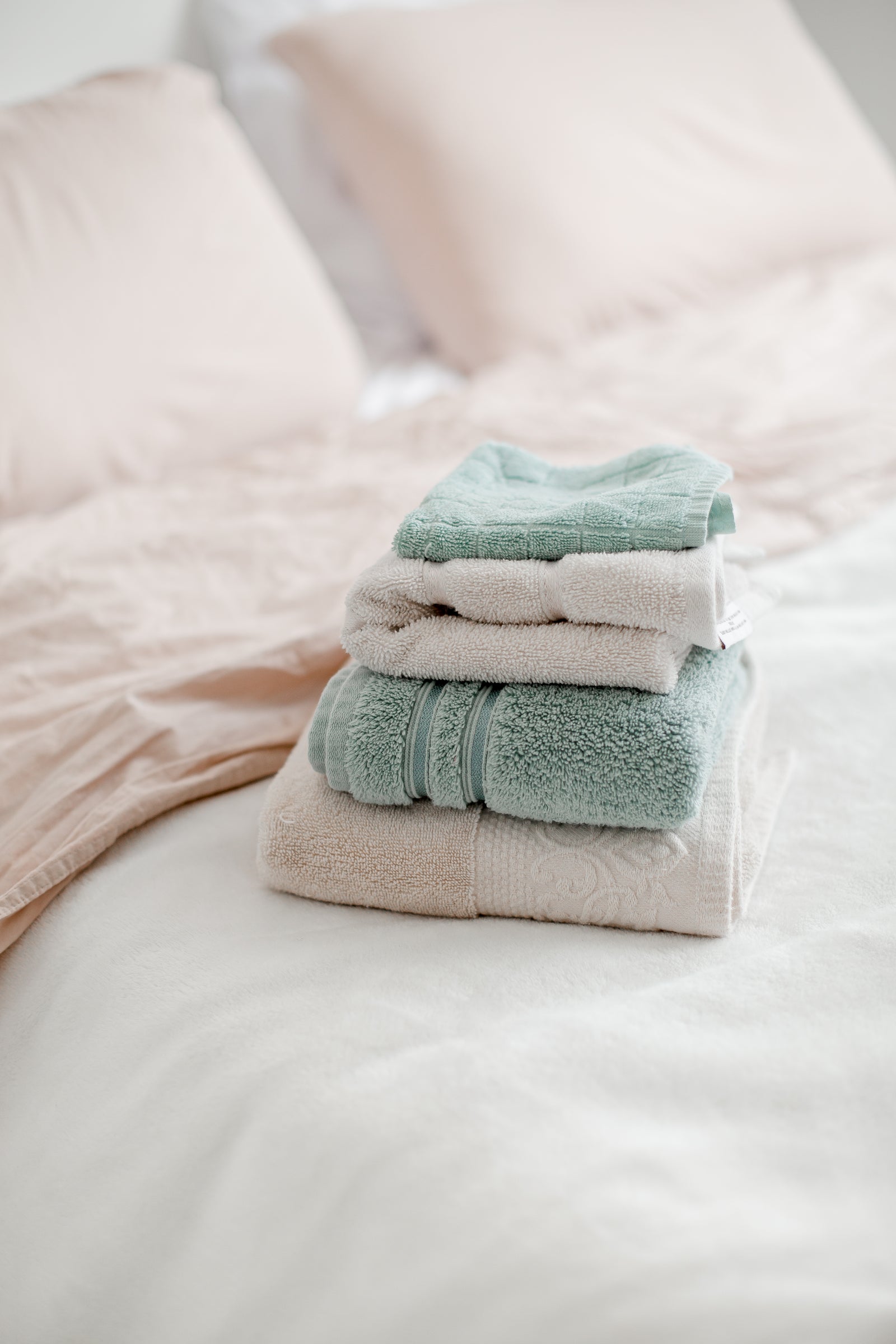 Neatly folded towels on a bed